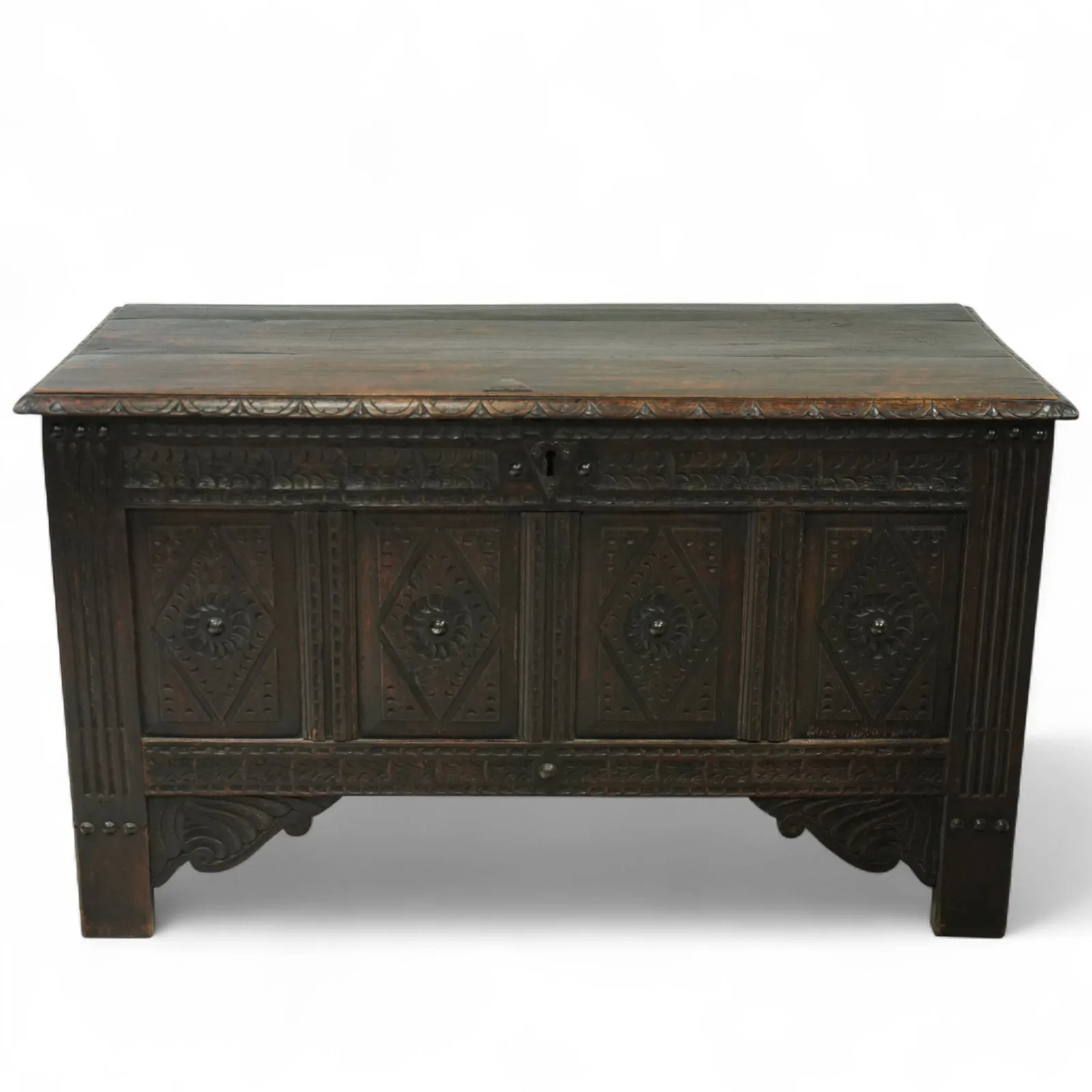 19th century carved oak coffer, rectangular plank top above a four-panel front carved with lozenges and flowerhead motifs, shaped lower apron and stile feet thumbnail 2