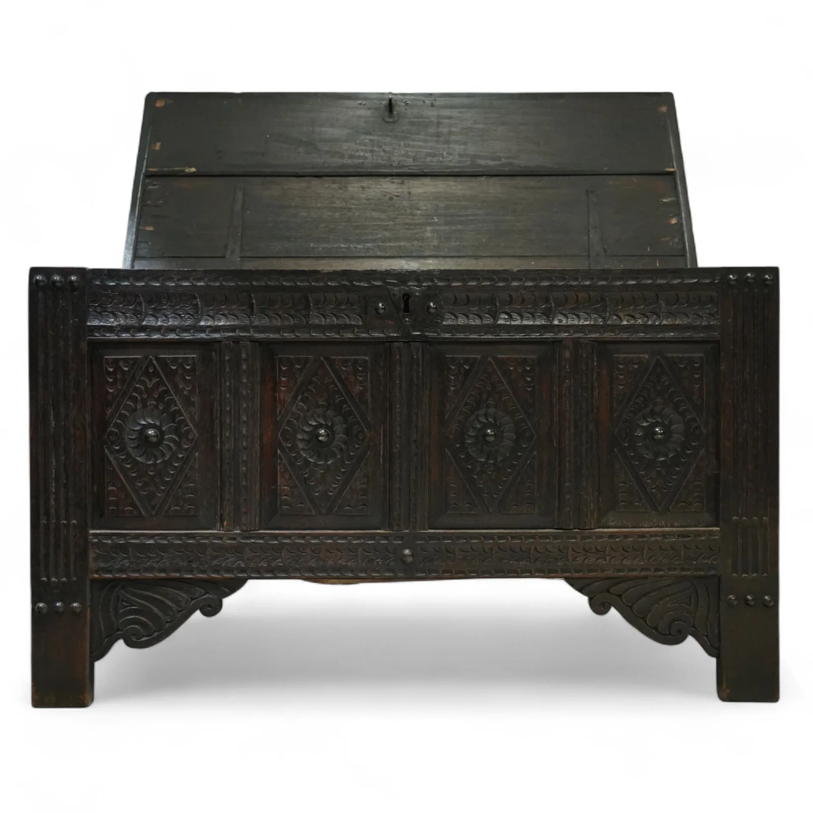 19th century carved oak coffer, rectangular plank top above a four-panel front carved with lozenges and flowerhead motifs, shaped lower apron and stile feet thumbnail 4
